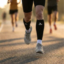 SA1NT LAYERS P1 Race Compression Calf Guards, worn outdoors on a road run