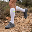 Trail runner wearing SA1NT LAYERS Compression Race Socks White Fluro Yellow